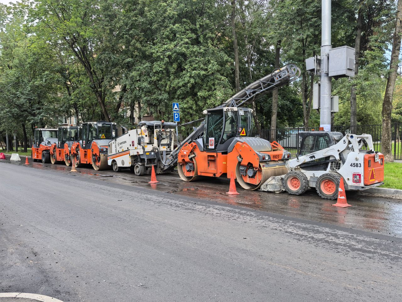 services-02 Heavy machinery lined up for road construction in a city.